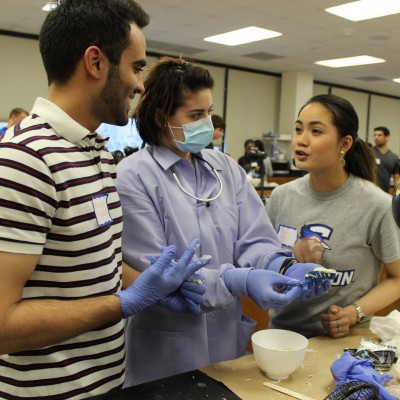 Dr. Lewin mentoring several high school students at Creighton SNDA's Impressions Day